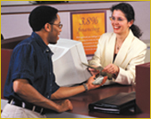 Man and woman at a bank counter.